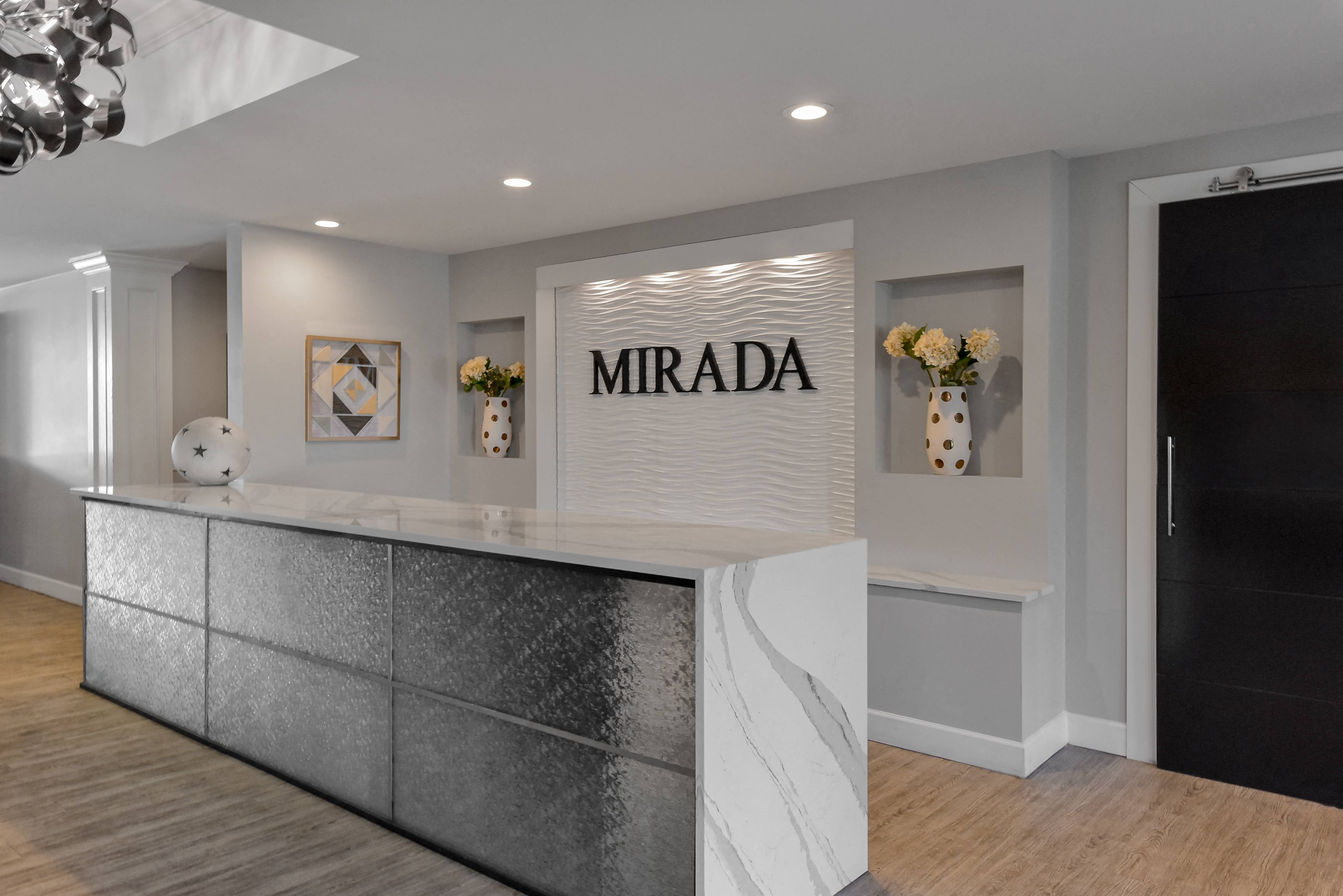 a reception area with a marble counter top and a sign that reads mirada